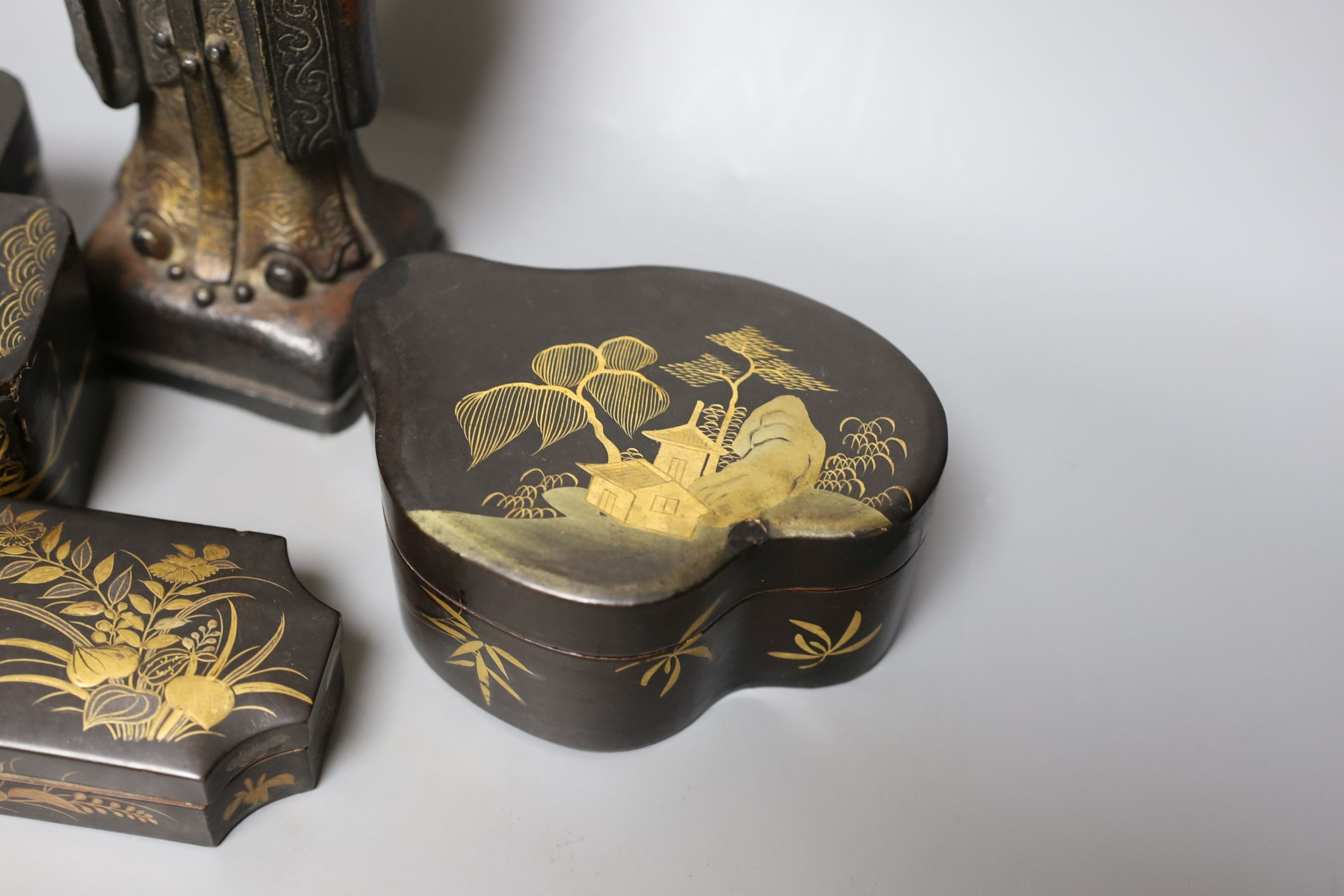 A Chinese bronze figure of an official and three Japanese lacquer boxes. Tallest 29cm